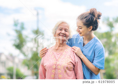nurse caregiver take care of Asian elderly woman 61978005