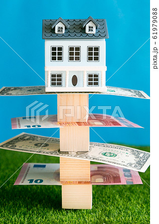 House toy on a bundle of paper money 61979088