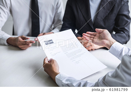Employer or committee holding reading a resume Employer or committee holding reading a resume 61981799