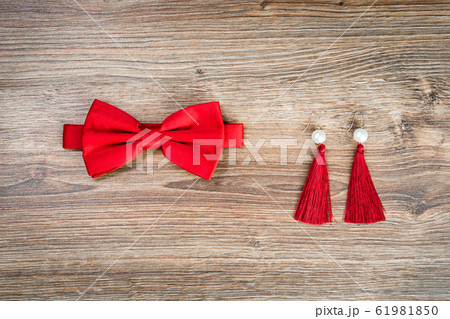 Red bow tie and earings lat lay for 14 February date Red bow tie and earings lat lay for 14 February date 61981850