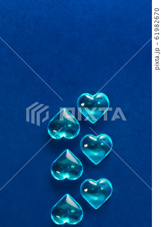 Glass blue hearts on a classic blue background. Symbol of LGBT love, Saint Valentine. Minimalism 61982670
