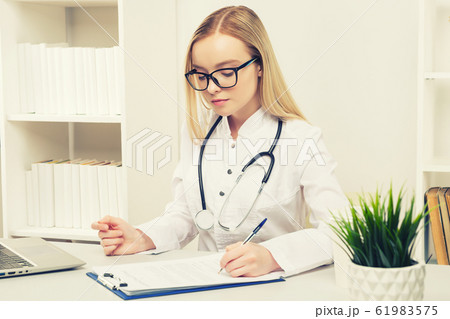 Young beautiful doctor woman working happy and 61983575