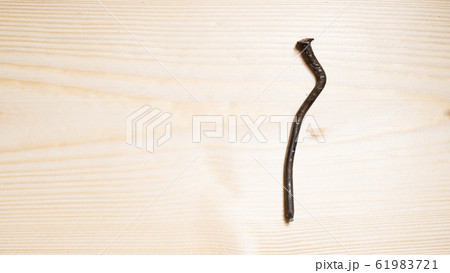 bent nail on a wooden board. Concept stoop, 61983721