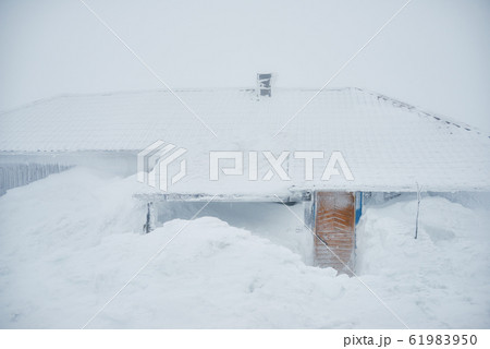 Little winter house covered with snow waiting for courageous travelers Little winter house covered with snow waiting for courageous travelers 61983950