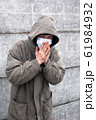 sick homeless in a medical mask caught a cold 61984932