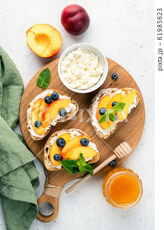 Sweet Bruschetta With Ricotta Cheese, Peach, Blueberries And Honey 61985623