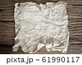 tear crumpled brown paper on wooden 61990117