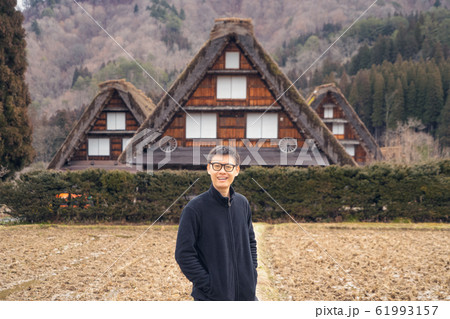 An Asian tourist man at Shirakawago village in 61993157