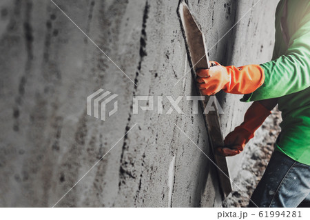 closeup hand worker plastering cement on wall for closeup hand worker plastering cement on wall for 61994281