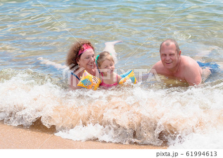 Grandparents And Granddaughter swimming in the Grandparents And Granddaughter swimming in the 61994613
