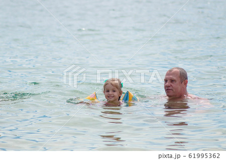 Grandparents And Granddaughter swimming in the Grandparents And Granddaughter swimming in the 61995362