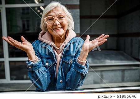 Happy mature woman standing outdoors stock photo Happy mature woman standing outdoors stock photo 61995646