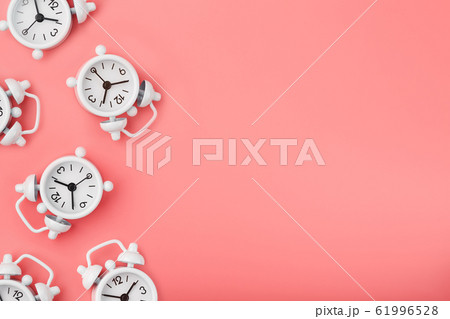 A pattern of many white classic alarm clocks in A pattern of many white classic alarm clocks in 61996528