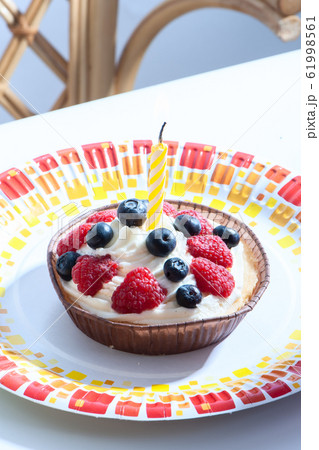 Birthday cake with a candle, with raspberries, Birthday cake with a candle, with raspberries, 61998561