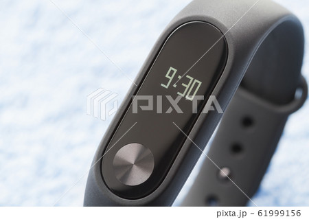 Black fitness watch (activity tracker) on the blue Black fitness watch (activity tracker) on the blue 61999156