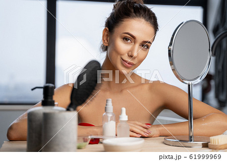 Girl resting her elbows on a dresser 61999969