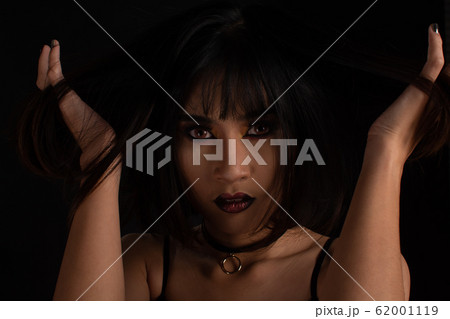 Weird woman with dark tone makeup on black 62001119