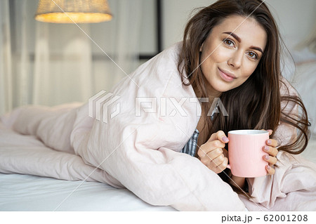 Peaceful young Caucasian lady enjoying her morning Peaceful young Caucasian lady enjoying her morning 62001208