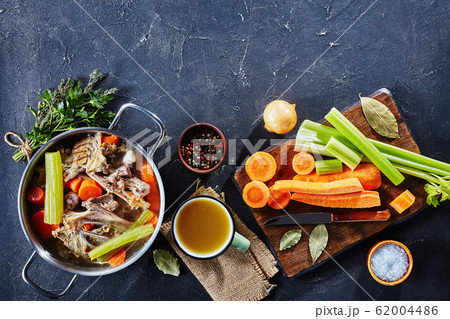 chicken stock in a pot and in a cup chicken stock in a pot and in a cup 62004486