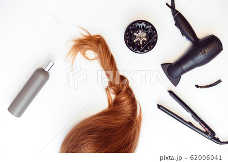 Set of tools dryer, iron and hair brush for hairstyle and red hair on white 62006041