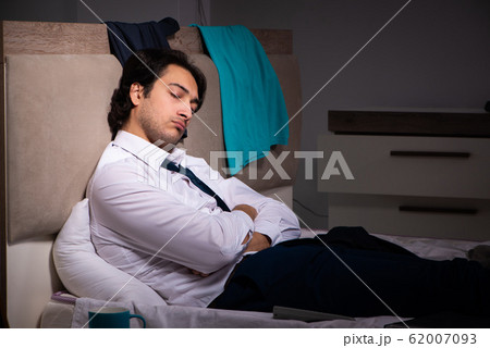 Young employee working at home after night shift Young employee working at home after night shift 62007093