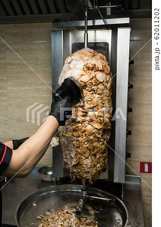 Chef hands chop chicken for doner kebab 62011202