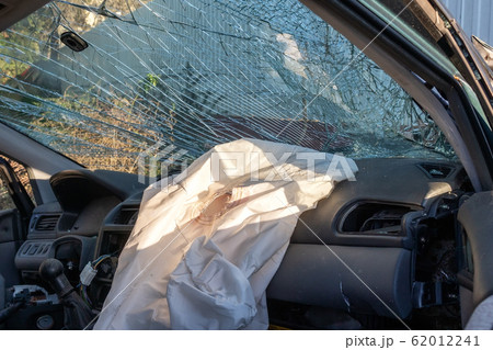 Blown up airbag after a car crash and broken glass. Problems drinking alcohol while driving. 62012241