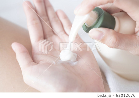 Woman applying moisturizing cream/lotion on hands, beauty concept.. Woman applying moisturizing cream/lotion on hands, beauty concept.. 62012676