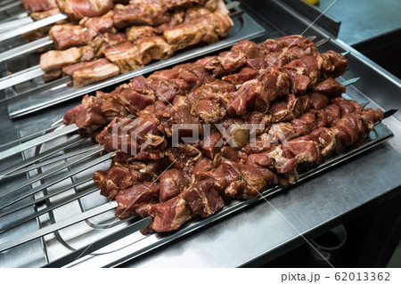 Raw meat on skewers in the kitchen 62013362