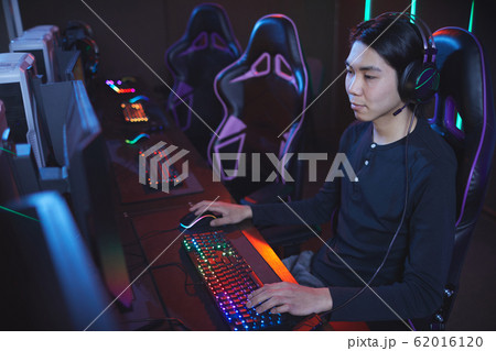Asian Man Playing Video Games in Computer Club 62016120