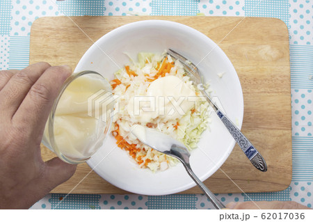 Chef putting cream salad to the bowl for cooking 62017036