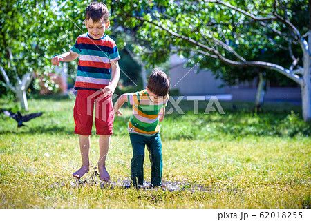 Little boy and his brother play in summer park. Little boy and his brother play in summer park. 62018255