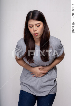 Young asian Woman stomachache over gray background 62018994