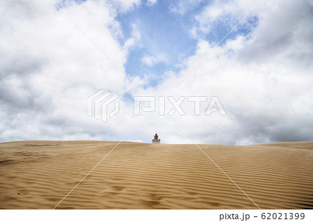 Lighthouse buried in a large sand dune 62021399