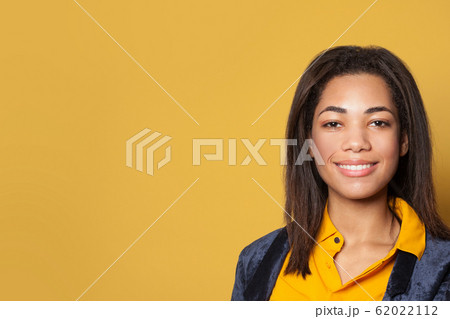 Young African American woman on yellow background Young African American woman on yellow background 62022112