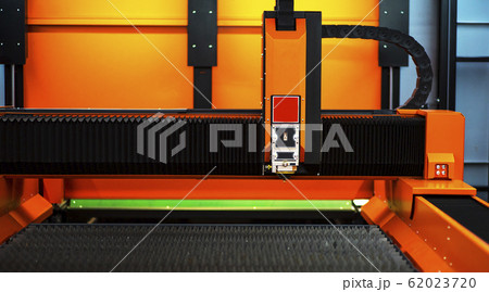 Sheet of metal and hands of worker who works on 62023720