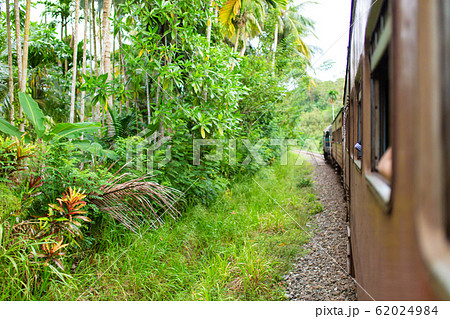 Train ride in Sri Lanka. Man hanging on a wagon 62024984