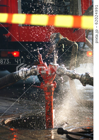 Water splashes from the fire hose and hydrant Water splashes from the fire hose and hydrant 62024991