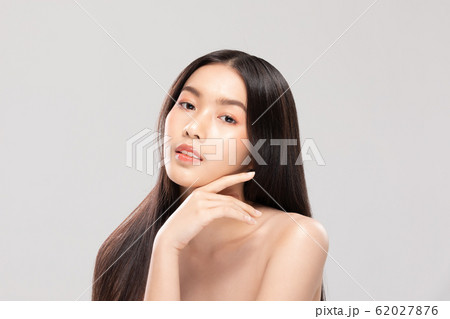 Beautiful Asian young woman touching soft cheek smile with clean and fresh skin Happiness and cheerful with positive emotional,isolated on white background,Beauty and Cosmetics Concept 62027876