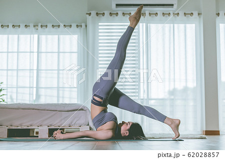 Asian woman practice yoga to meditation in bedroom 62028857