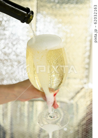 Woman pouring overflowing glass of wine Woman pouring overflowing glass of wine 62032163
