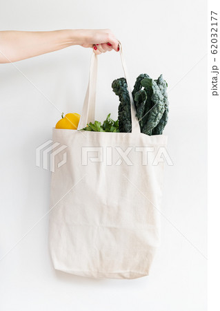 Woman holding bag of vegetables 62032177