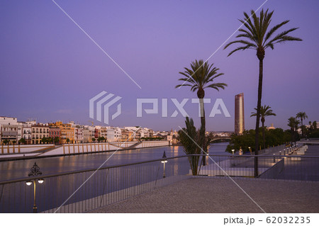 Palm trees in front of Sevilla Tower at sunset in Seville, Spain 62032235