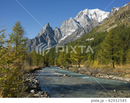 Snowcapped mountain by river in Aosta Valley, Italy 62032585
