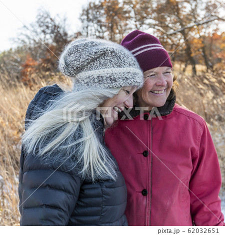 Smiling women wearing winter clothing Smiling women wearing winter clothing 62032651