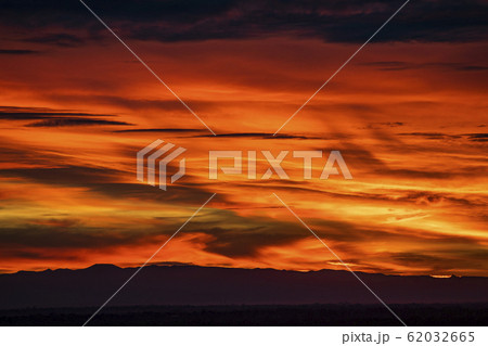 Silhouette of hills under dramatic sunset sky Silhouette of hills under dramatic sunset sky 62032665