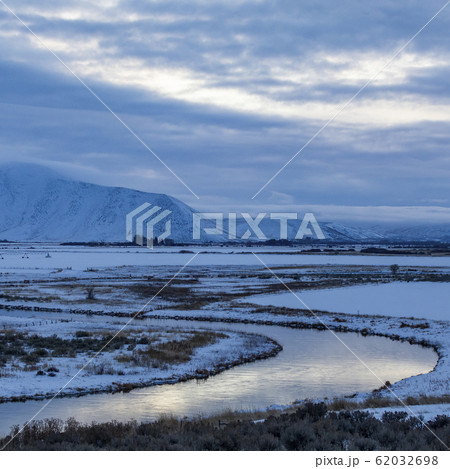 River by snowcapped mountain River by snowcapped mountain 62032698