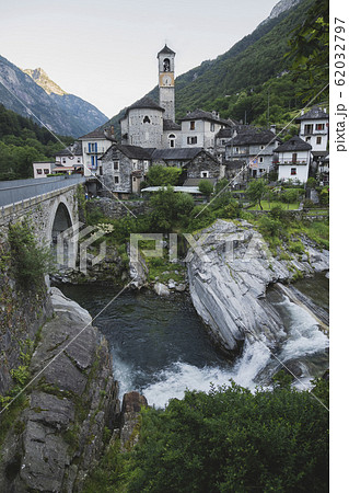 Bell tower by bridge and river in Ticino, Switzerland Bell tower by bridge and river in Ticino, Switzerland 62032797