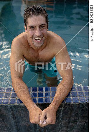 Young man relaxing in the swimming pool Young man relaxing in the swimming pool 62033803