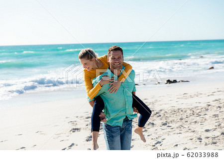 Couple having fun at the beach Couple having fun at the beach 62033988